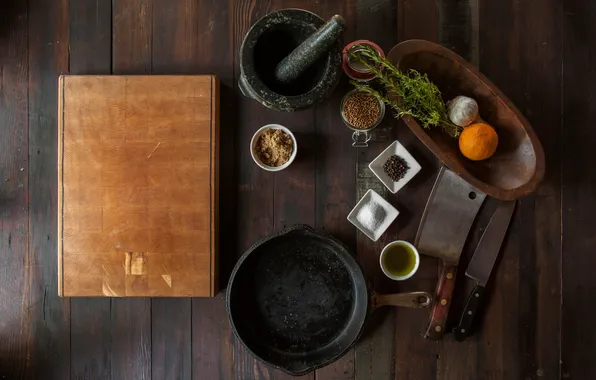 Table, knife, dishes, spices, mortar, pan