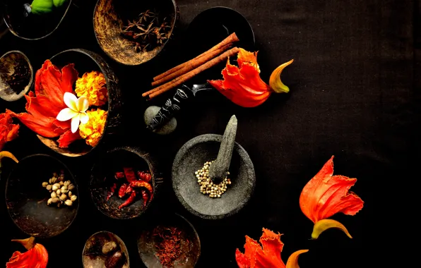 Table, petals, spices, mortar, star anise, pepper, bowls