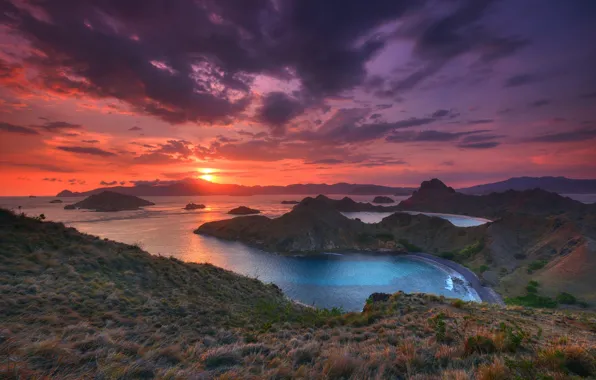 Sea, grass, the sun, clouds, sunset, mountains, clouds, rocks