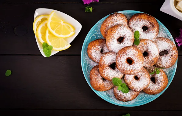 Plate, donuts, slices, powdered sugar, lemon