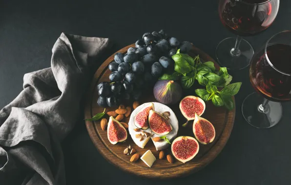 The dark background, table, wine, towel, cheese, glasses, grapes, fruit