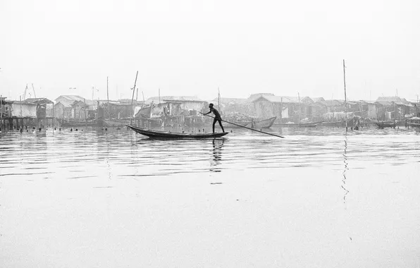 Picture river, boy, canoe, poverty, stilt houses