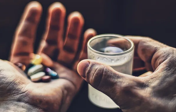 Picture glass, hands, pills