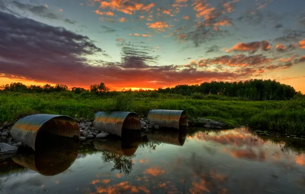 Picture the sky, grass, trees, pipe