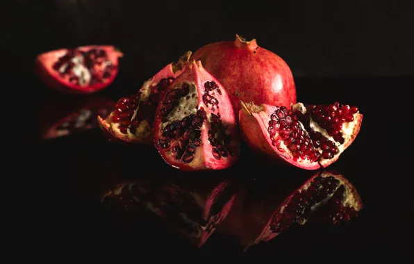 Reflection, the dark background, table, grain, fruit, grenades, slices, garnet