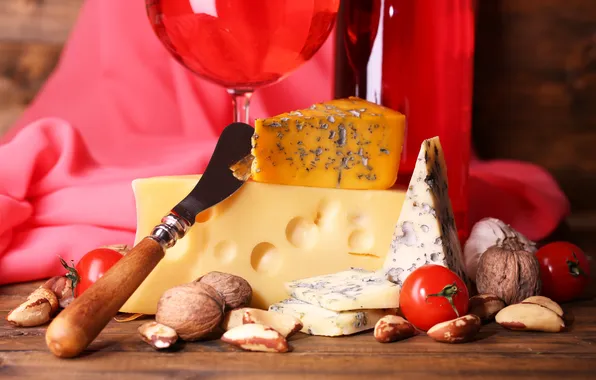 Cheese, knife, nuts, tomatoes
