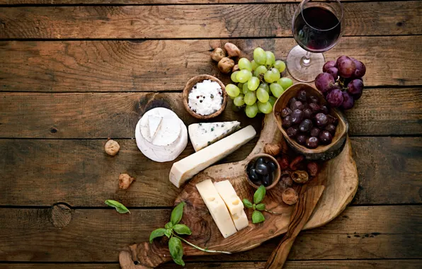 Glass, cheese, grapes, olives, red wine
