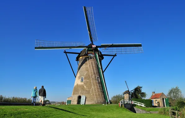 The sky, grass, people, windmill