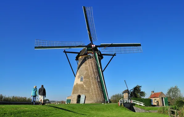 Picture the sky, grass, people, windmill