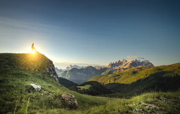 The sky, grass, the sun, clouds, mountains, shadow, male, sunlight