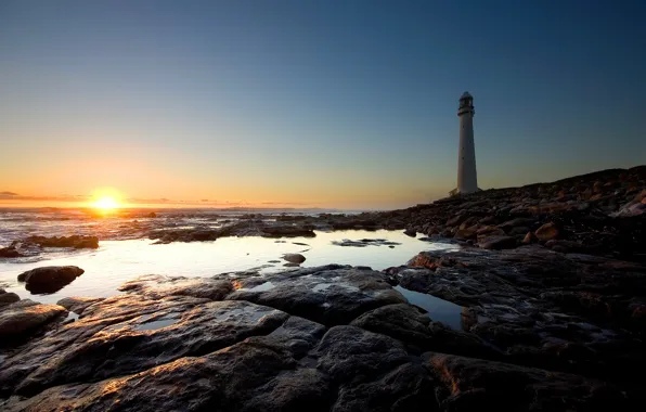 The sun, stones, shore, lighthouse
