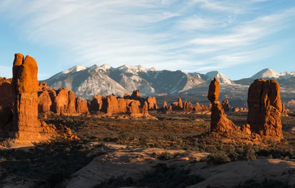 Clouds, light, mountains, stones, rocks, vegetation, posts, desert