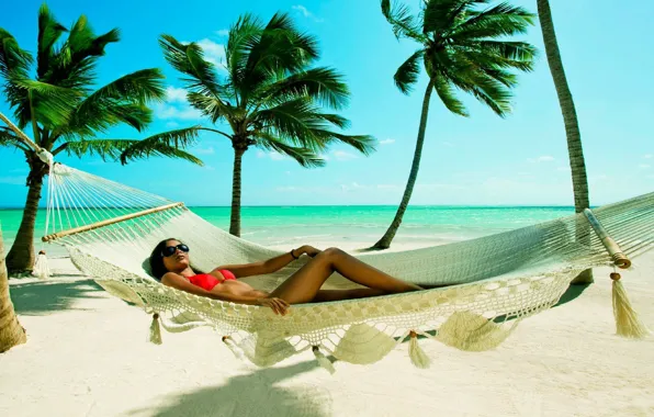 Girl, palm trees, the ocean, hammock
