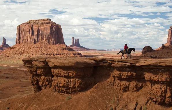 Cowboy, mountains clouds