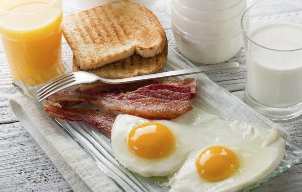 Milk, juice, scrambled eggs, bacon, toast