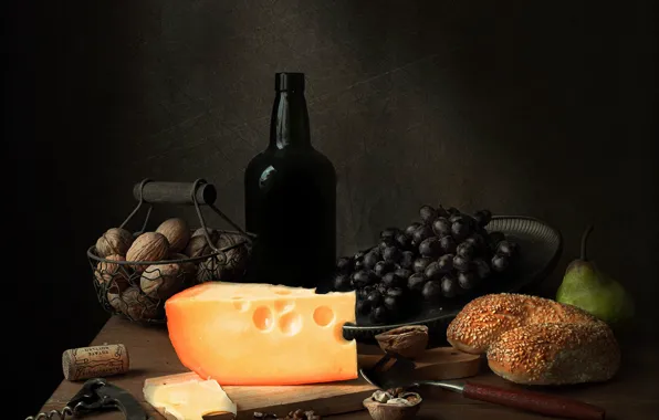 The dark background, table, wine, bottle, food, cheese, tube, nuts