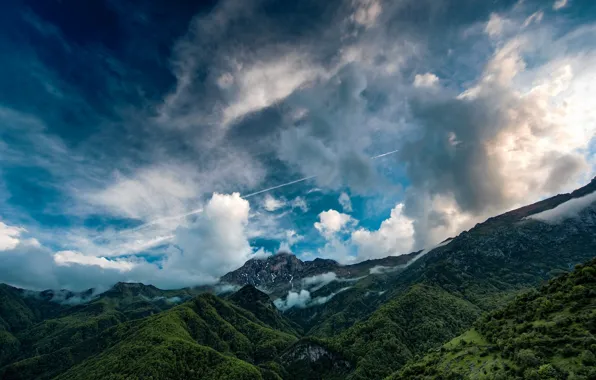 The sky, clouds, trees, mountains, the slopes