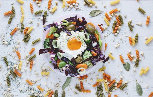 Scrambled eggs, vegetables, olives, salad, spices, pasta, pasta