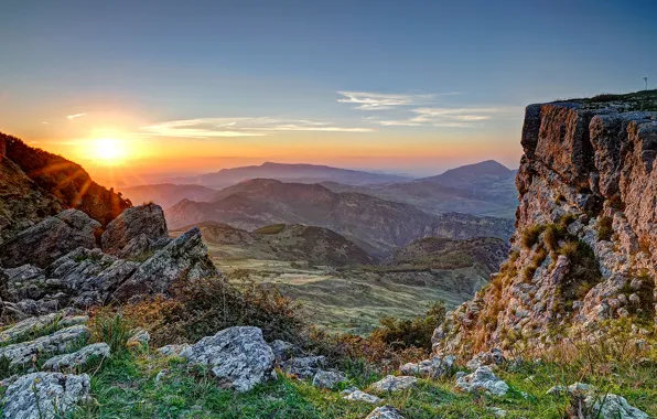 Picture the sky, grass, sunset, mountains, stones, rocks