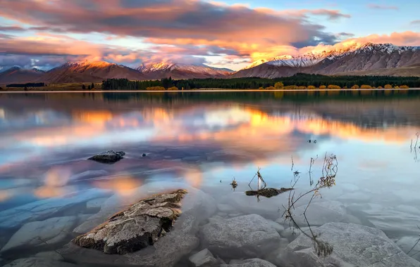 The sky, transparency, clouds, snow, sunset, mountains, lake, stones
