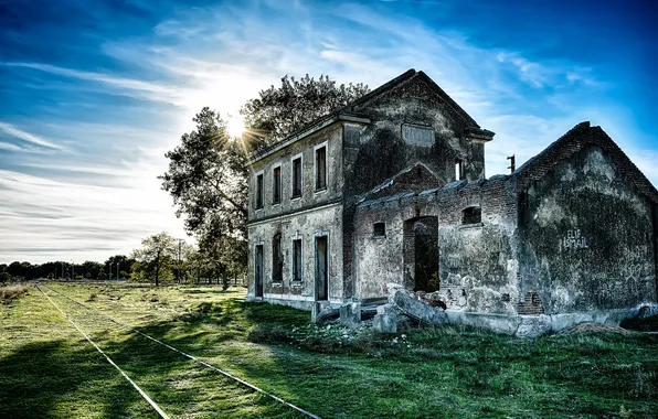 Picture the sky, the sun, clouds, trees, shadow, railroad, devastation, abandoned