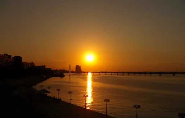 The sun, sunset, bridge, the city, glare, reflection, river, the evening