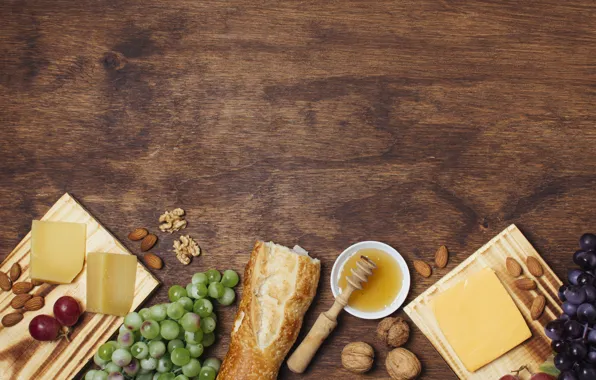 Cheese, bread, grapes, nuts, honey, baguette