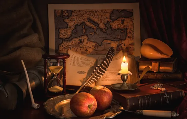 Pen, apples, books, map, candle, tube, shell, still life