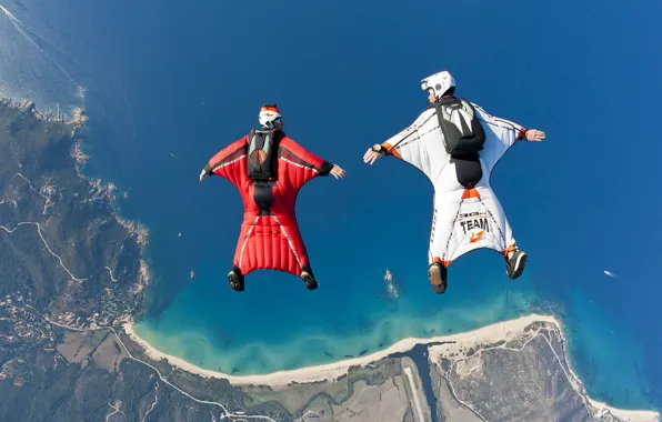 The sky, water, the ocean, shore, mountain, skydivers, skydivers