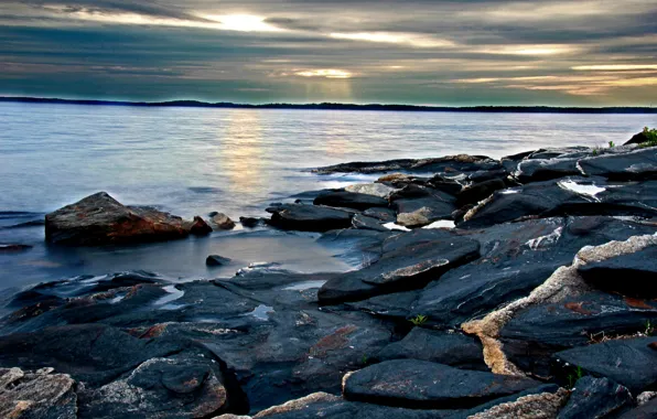 Picture the sky, water, the sun, rays, clouds, stones, shore