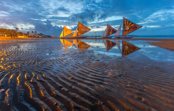 Sand, sea, the sky, lights, shore, boat, people, the evening