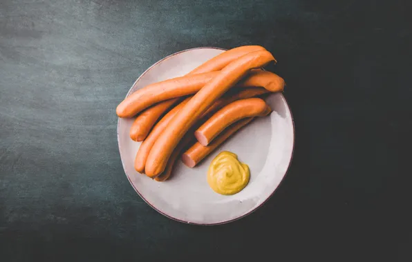 The dark background, sausage, minimalism, plate, sauce, mustard, very simple