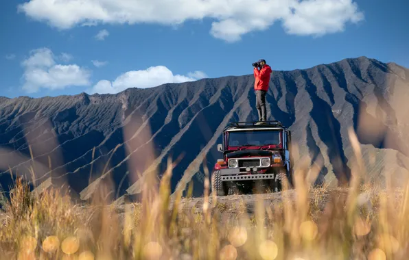 Field, machine, mountains, jeep, photographer, male, shooting, bokeh
