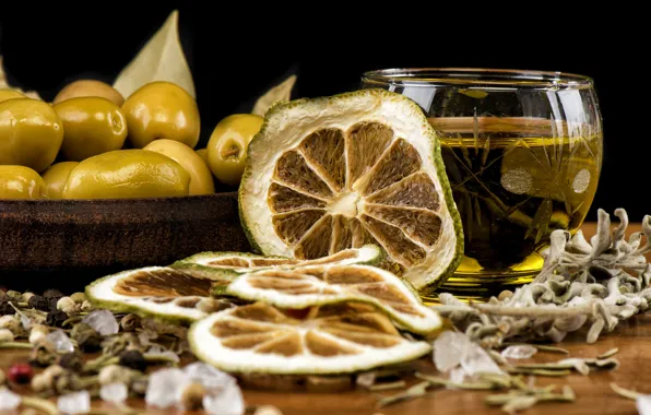 Leaves, table, glass, oil, lime, pepper, bowl, black background