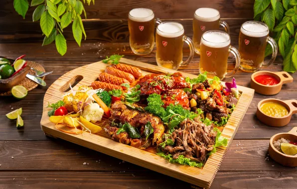 Sausage, beer, meat, vegetables, salad, sauces