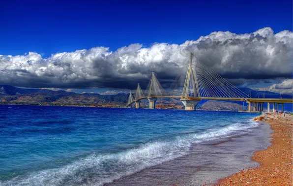 Picture the sky, water, clouds, bridge, pebbles, shore, colored, Greece