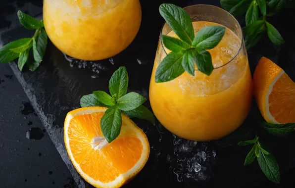 Drops, the dark background, table, ice, oranges, glasses, juice, cocktail