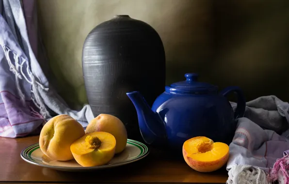The dark background, table, towel, kettle, plate, dishes, pitcher, fruit