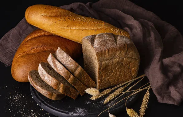 The dark background, towel, spikelets, bread, fabric, ears, cutting, baton