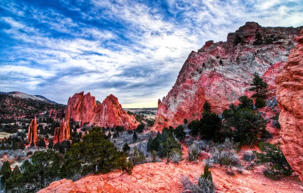 The sky, clouds, trees, mountains, rocks