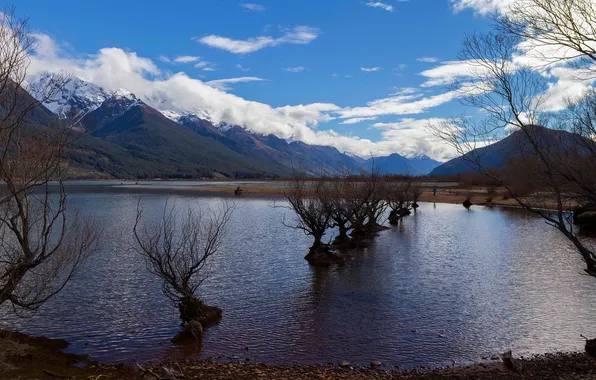 The sky, clouds, trees, mountains, lake