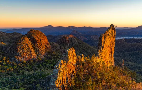 The sky, trees, mountains, rocks, glow