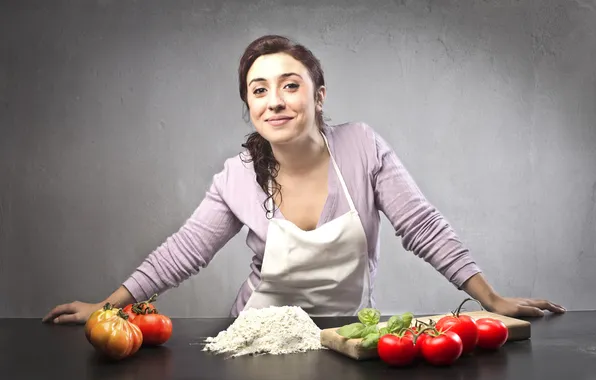 Picture girl, smile, table, cook, tomatoes, apron, flour