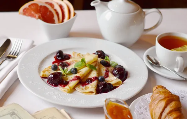 Tea, honey, pancakes, jam, croissant