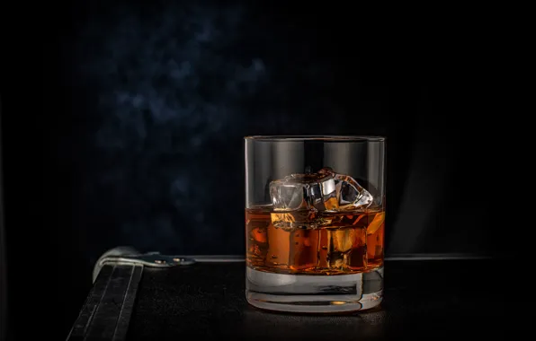 Picture glass, ice, whiskey, the dark background