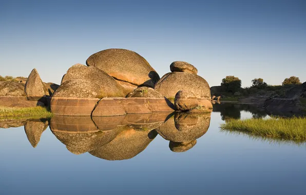 The sky, grass, water, lake, stones