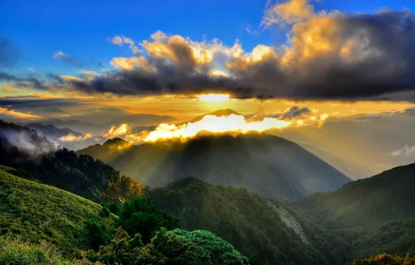 The sun, rays, mountains, clouds, fog, morning