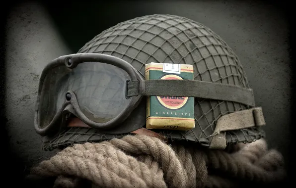 Glasses, helmet, a pack of cigarettes, army