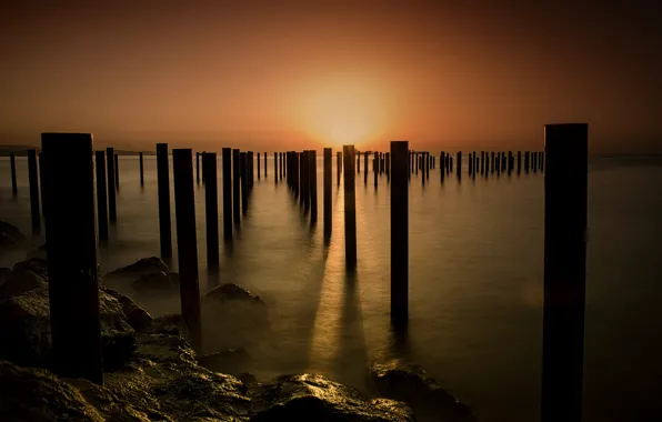 Sea, sunset, shore, posts