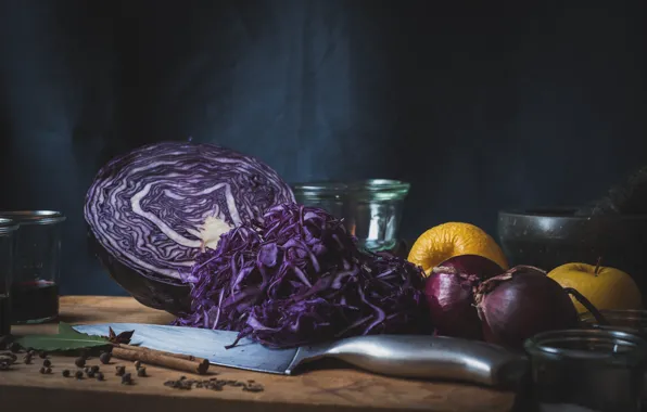 The dark background, apples, bow, knife, dishes, cabbage, spices, cutting Board